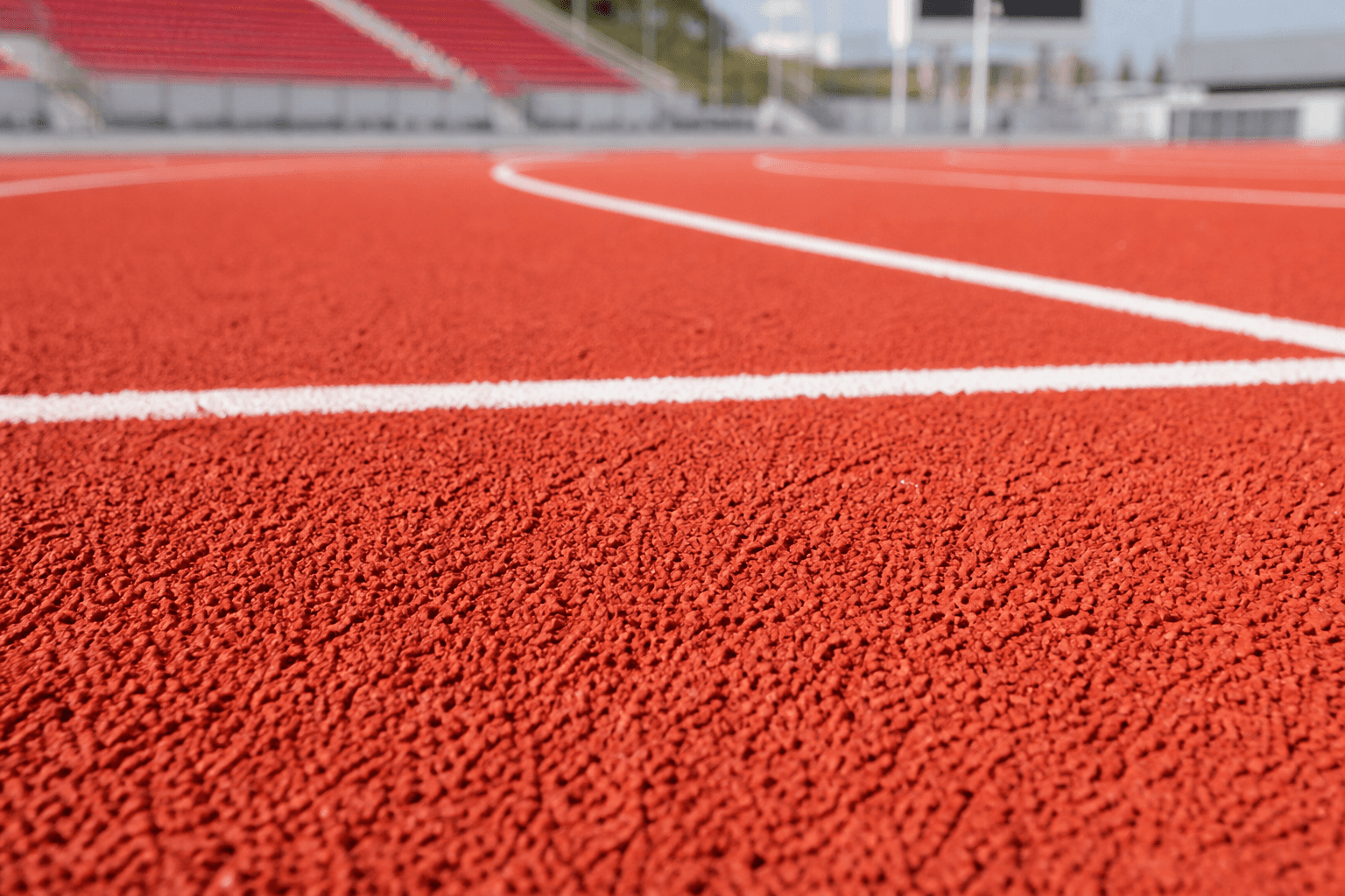 Sports track surface using fine rubber granules