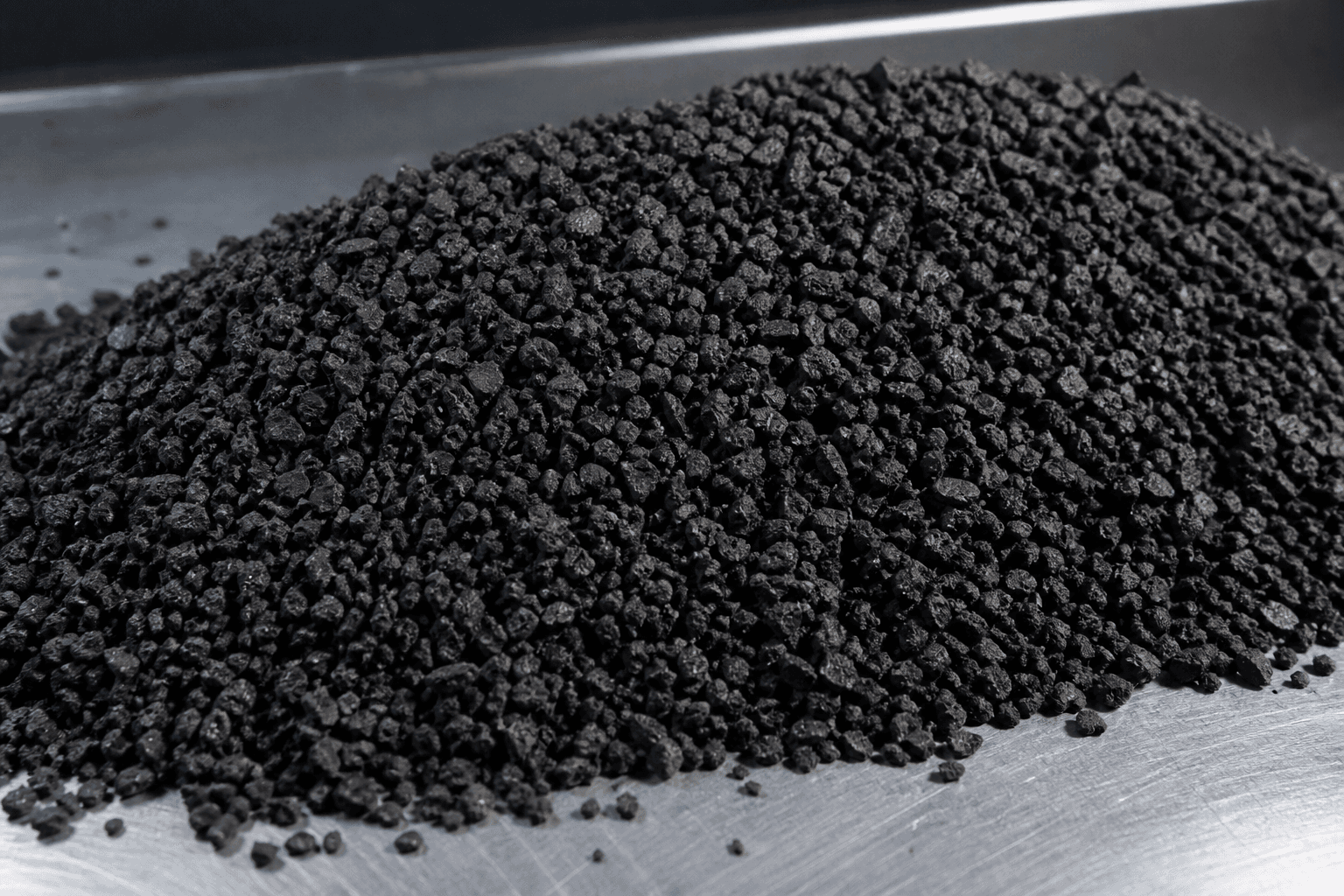 Fine recycled rubber granules on industrial surface